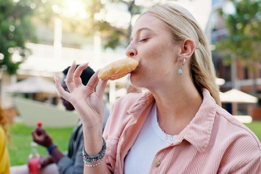 A person holding a donut. 1