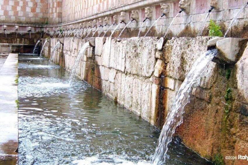 A water channel with multiple stone structures and water flowing through it. 4