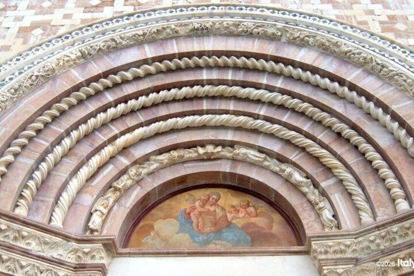 A detailed architectural arch with a fresco mural. 2