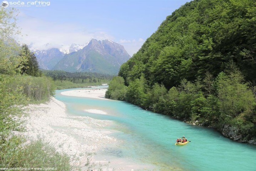 A river with a raft, surrounded by forest and mountains. 3