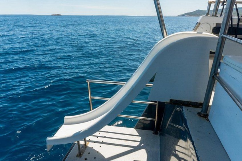 A boat with a white deck and a metal railing. 3
