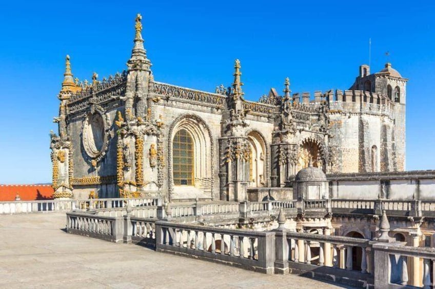 A historic building with ornate architecture, including a large arched window and decorative columns. 4