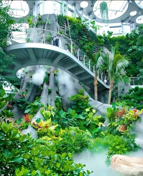 A green indoor garden with a curved bridge, lush plants, and a misty atmosphere. 2