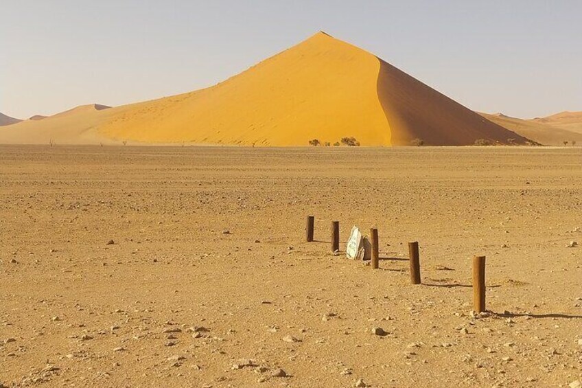 A desert landscape with sand dunes and wooden posts. 5