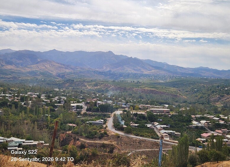 A mountainous landscape with a town nestled in the valley. 5
