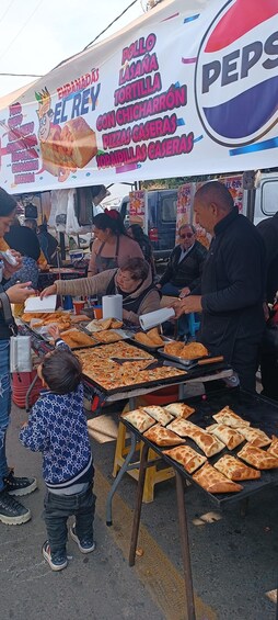 A street food stall with a variety of snacks and a Pepsi advertisement in the background. 5