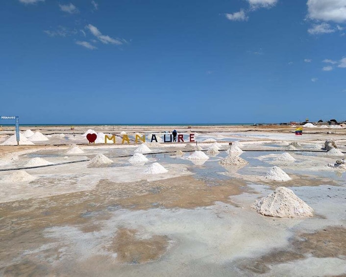 A salt flat with white salt formations and a clear blue sky. 3