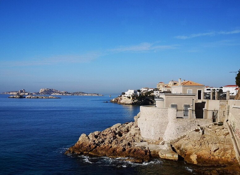 A coastal town with buildings on a cliff overlooking the sea. 3