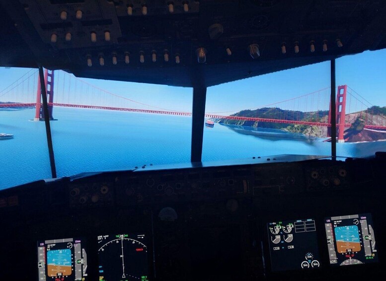 The interior of an aircraft cockpit with multiple instrument panels and a view of the Golden Gate Bridge. 2