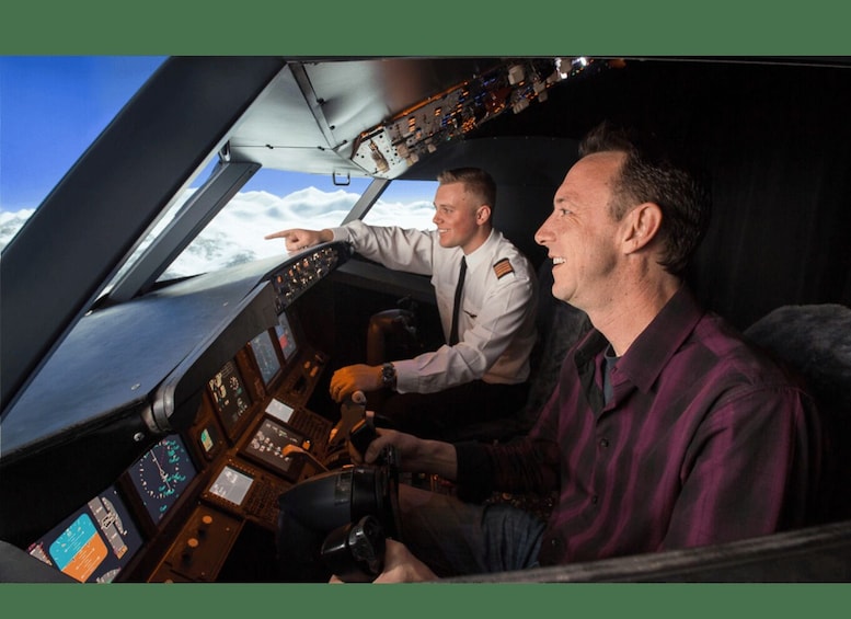 A cockpit with two pilots, one in a white uniform and the other in a plaid shirt, with a view of clouds outside. 1