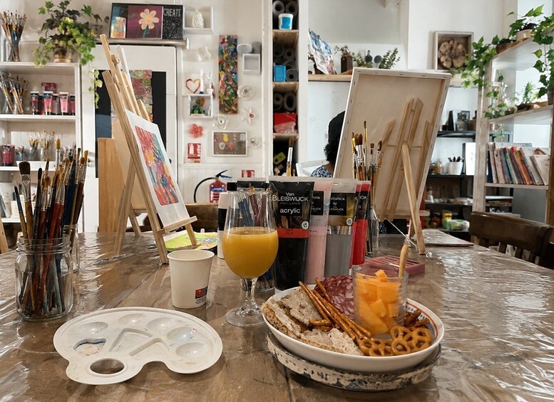 An art studio with easels, paintbrushes, and art supplies. 1