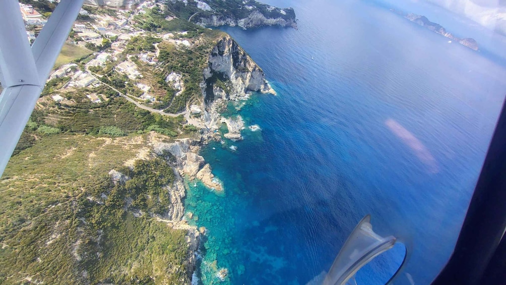 A coastal landscape with cliffs and a clear blue sea. 5