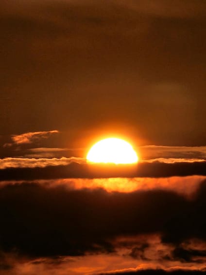The sun partially obscured by clouds. 4