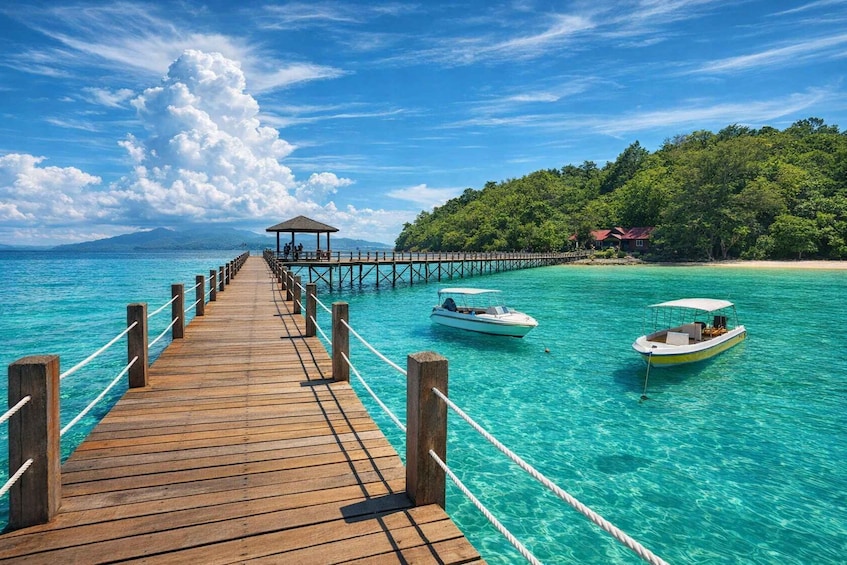 A wooden pier extending into turquoise waters, with two boats anchored nearby and a small structure at the end. 4