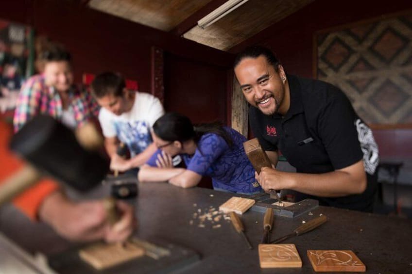 A person using a power tool on a workbench with wooden blocks and a hammer. 4