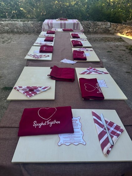 A table set outdoors with folded napkins and placemats. 5