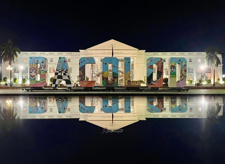 A building with large letters spelling 'BACOLOD' and colorful murals on the letters. 1