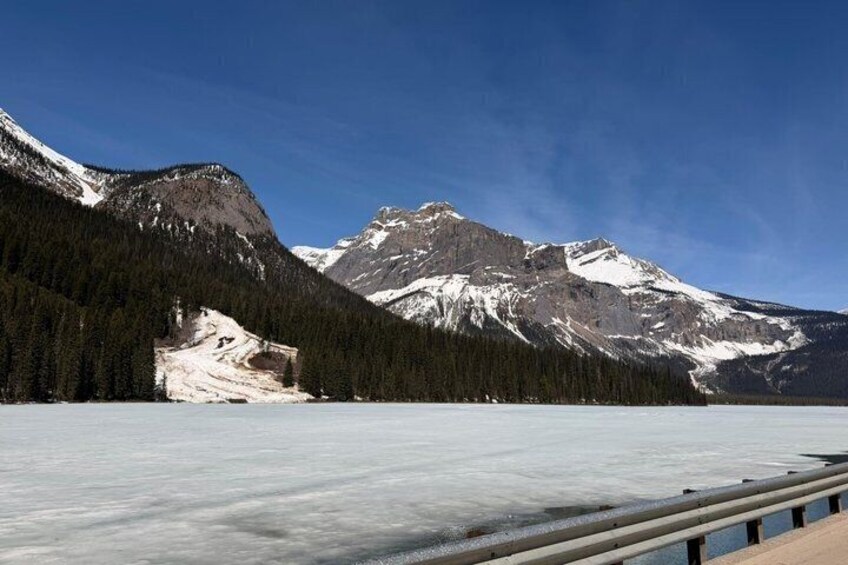 A frozen lake with mountains in the background. 2