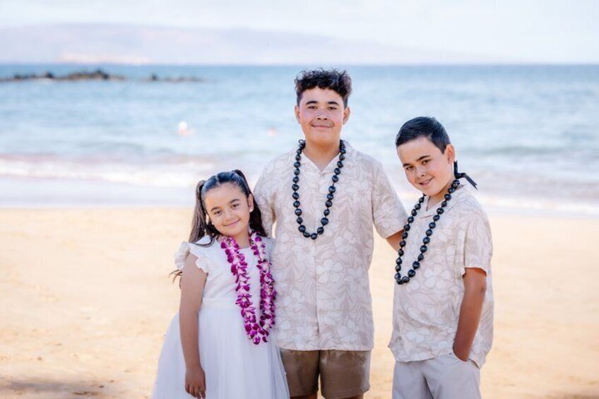 Three individuals on a beach with ocean in the background. 2