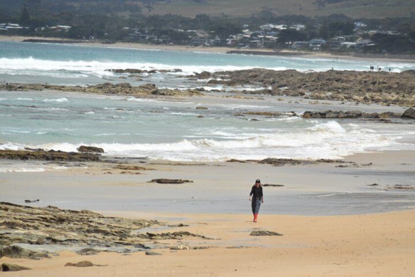 A beach with rocky terrain and waves. 4