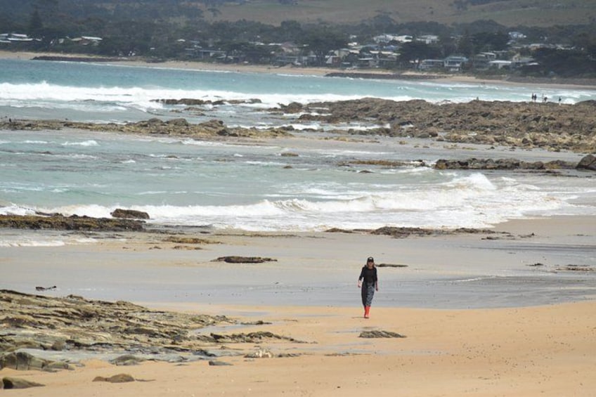A beach with rocky outcrops and waves. 4