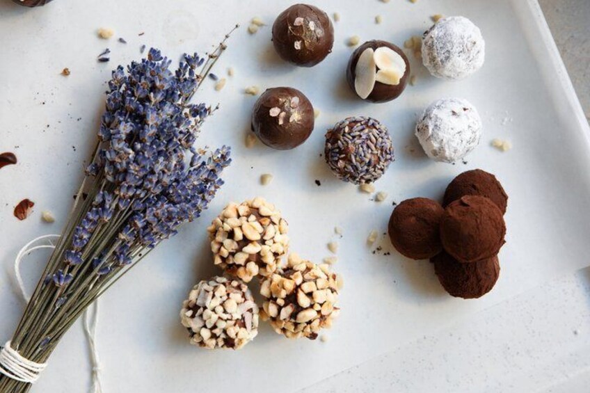 A variety of food items including chocolate truffles, nuts, and lavender. 1