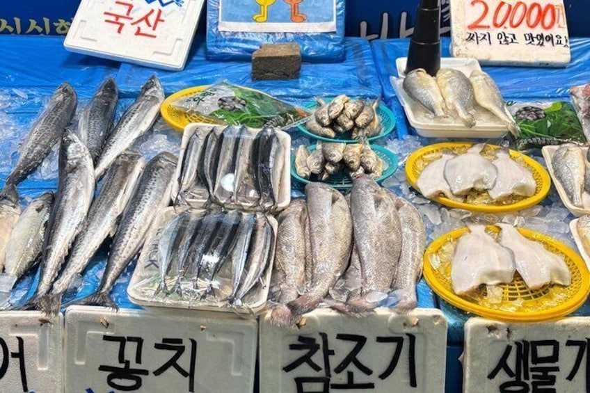 A variety of fresh seafood displayed at a market stall. 2