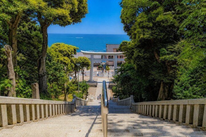 A staircase leading to a building with a view of the sea. 1