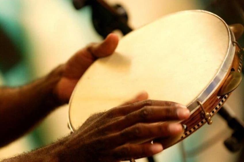 A person holding a tambourine. 4