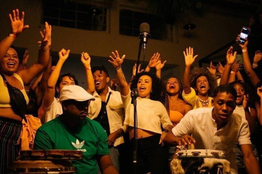 A group of people dancing and raising their hands in celebration. 5