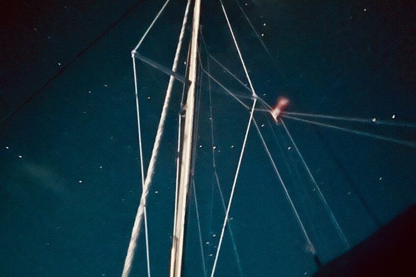 A geometric structure with intersecting lines and a red light at the center. 2