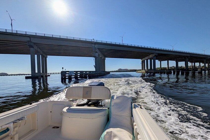 A boat on a river with a bridge in the background. 5