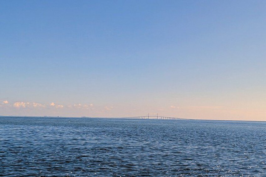 A calm sea with a distant bridge. 3
