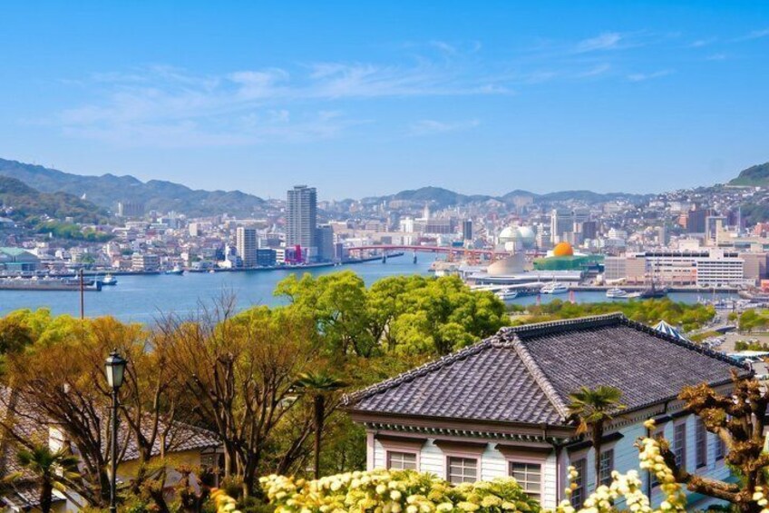 A cityscape with a river, a traditional building, and a modern skyscraper. 2