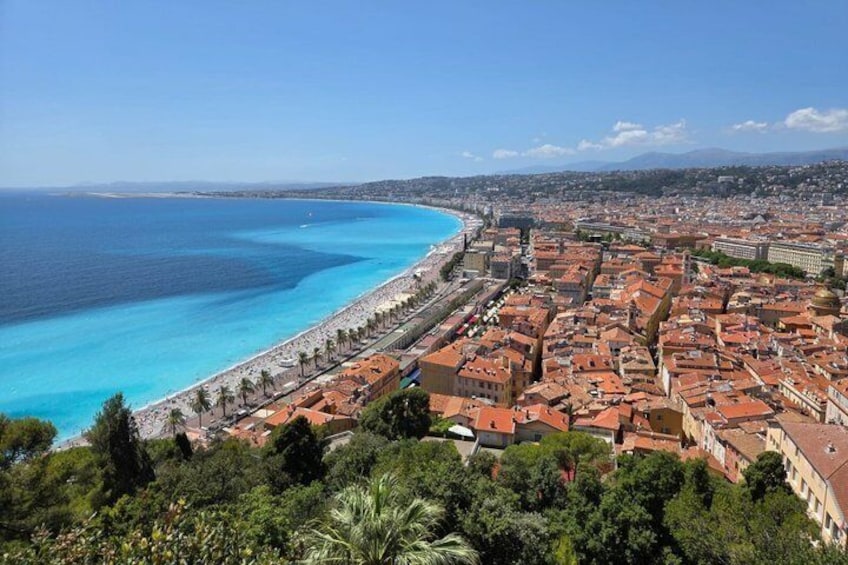 A coastal city with a beach, dense urban area, and surrounding greenery. 4