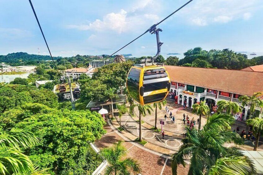A cable car system, lush greenery, and a traditional building with a red roof. 2