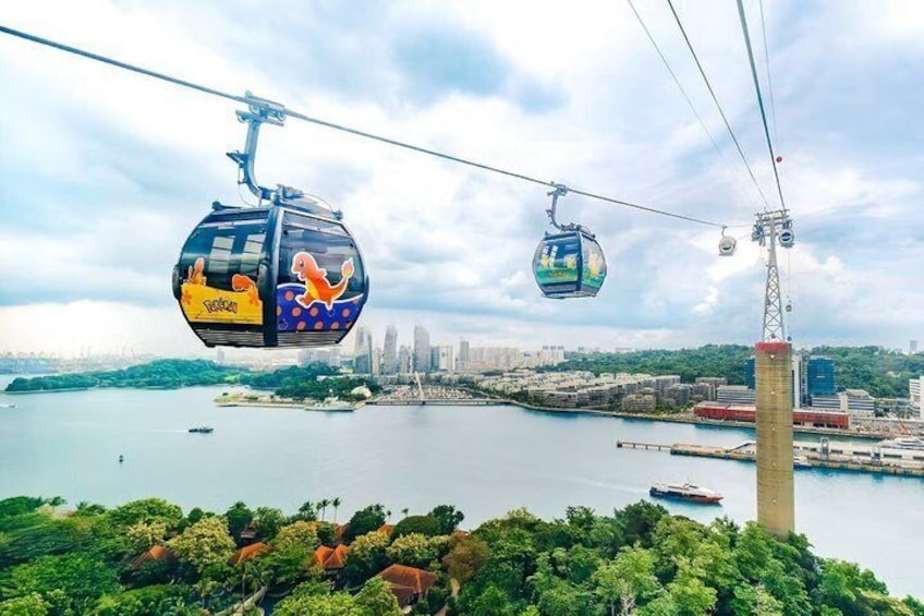 A cable car system over a body of water with a city skyline in the background. 1