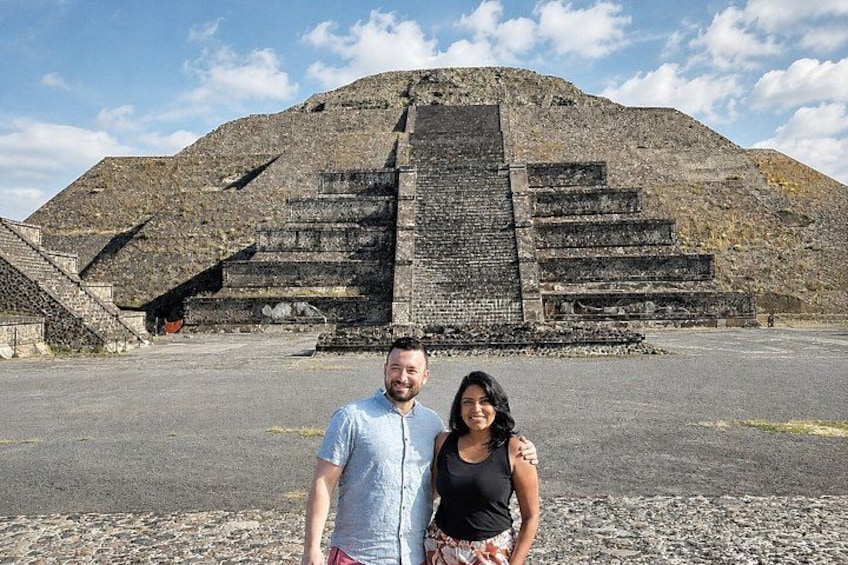 A large ancient pyramid with multiple levels and a staircase leading up to it. 5
