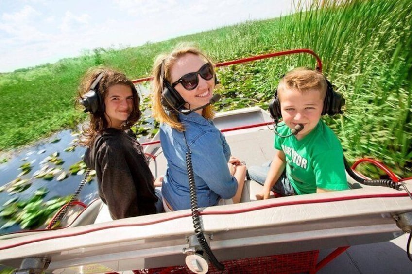 A boat ride through a waterway with vegetation on the sides. 2