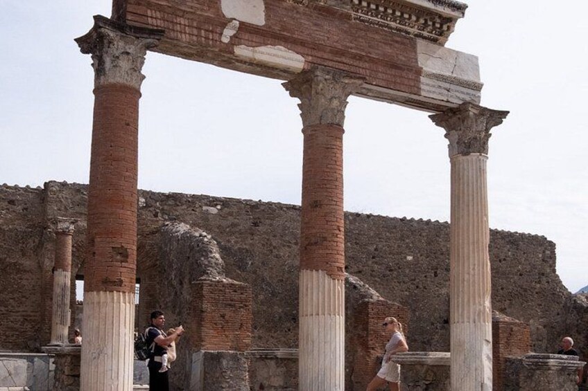 Ancient ruins with columns and a stone wall. 5