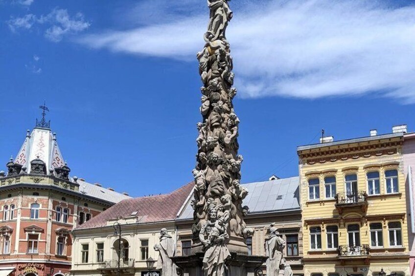 A statue in a square with buildings in the background. 5