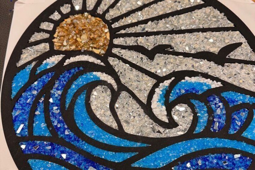A mosaic with blue and silver elements, possibly depicting a sun and waves. 3