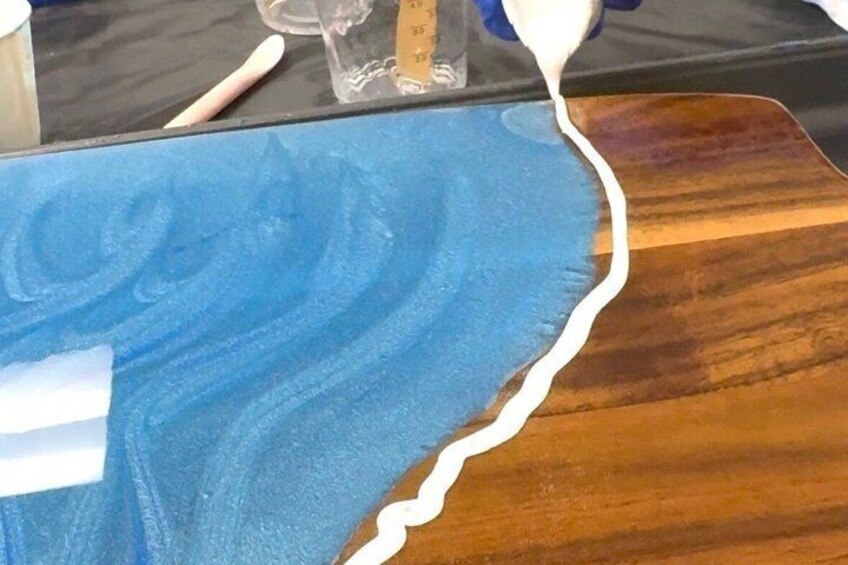 A wooden surface with a blue painted area and a white string. 5