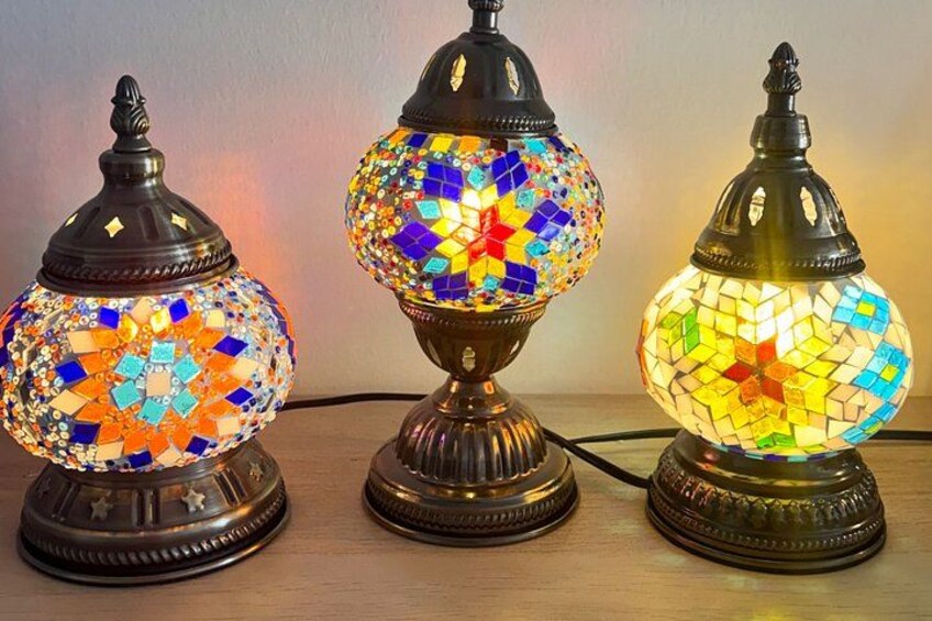 Three mosaic table lamps with ornate bases. 1