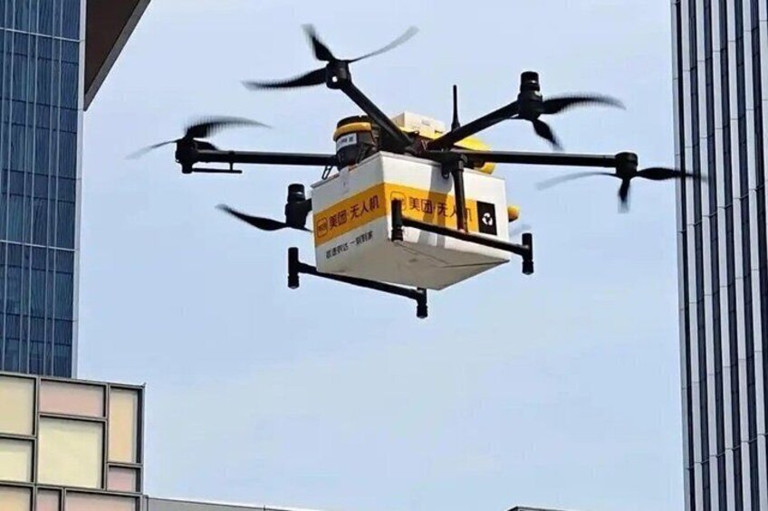 A drone with four propellers flying in an urban environment. 2