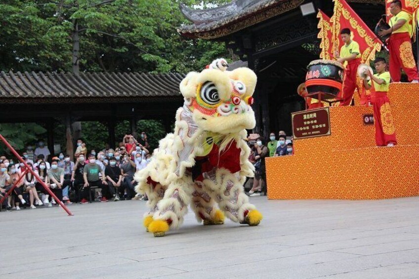 A lion dance performance with performers in a traditional lion costume. 1
