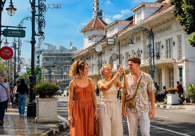 A street scene with pedestrians, historic buildings, and street lamps. 1