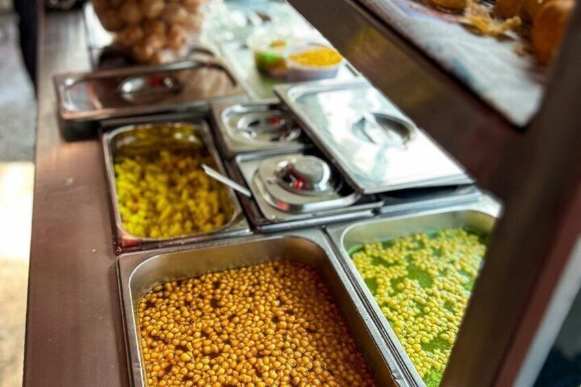 A buffet with various food items in metal containers. 4