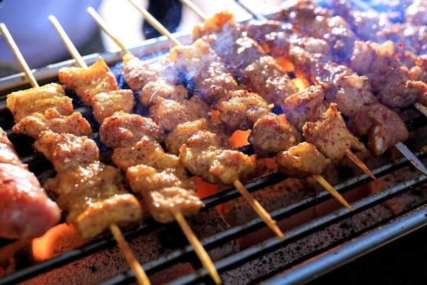 Skewered meat grilling on a barbecue. 1