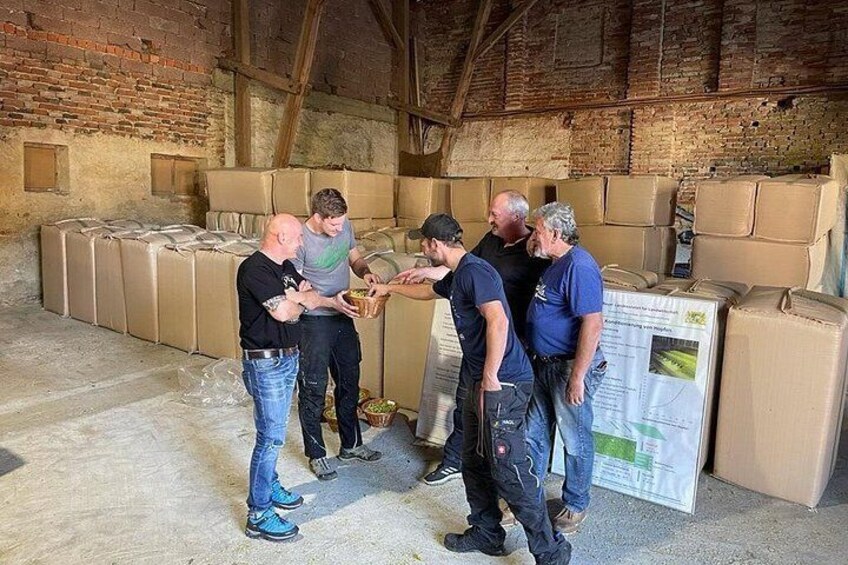 A group of people in a warehouse with boxes and a poster. 4